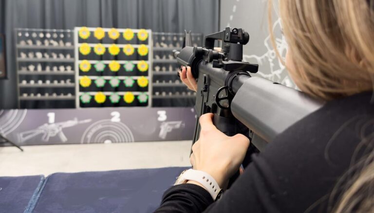 Woman demonstrating the use of plastics in a firearms application